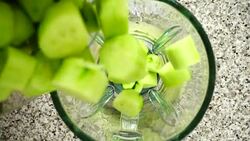 Falling of cucumbers in a blender bowl. Slow motion.	Shooting in kitchen. Top view. Stock Footage