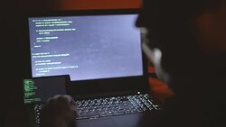 Hacker laughing while talking on the phone Stock Footage