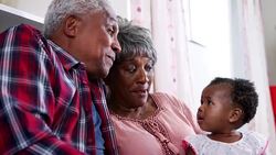 Grandparents singing to baby granddaughter at home - shot in slow motion Stock Footage