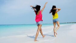 African American Asian Chinese girls on vacation beach Stock Footage