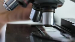 Microscope lens is approaching to the subject glass where the explore sample Stock Footage