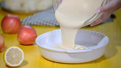 Female chef hands pouring batter into baking dish. The stage of cooking apple pie Charlotte. Stock Footage