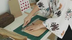 Woman artist is cutting paper Stock Footage