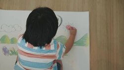 Boy is drawing and crayon of dinosaur Stock Footage