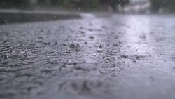 SLOW MOTION, CLOSE UP: Heavy rain water drops falling into puddle on the street Stock Footage
