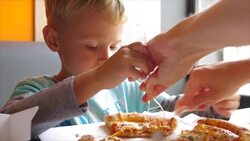 closeup of little cute boy eating pizza Stock Footage