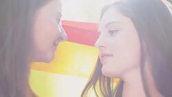 Lesbians walking with rainbow flag on march for equality, kissing tenderly Stock Footage