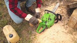 Lumberjack fixing / maintain the chainsaw outdoors. Stock Footage