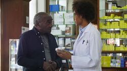 Pharmacist explaining medication to senior man Stock Footage