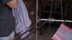 Woman hanging laundry on balcony Stock Footage