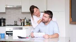 Happy couple calculating home bills Stock Footage