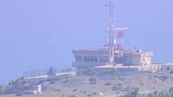 Wide shot of a Signal tower upon a hilltop News Clip