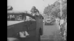 Getulio Vargas's casket carried in Rio de Janeiro procession; soldiers guard US embassy; Filho at table News Clip