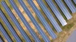 Aerial view: Rows Solar Panel Power Plant Providing Clean Renewable Energy Stock Footage