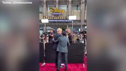Ke Huy Quan surprises Harrison Ford on Indiana Jones red carpet Instructional Video