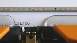 Close up footage of a person writing ISLAMOPHOBIA on an old typewriter Stock Footage