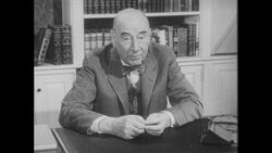 1960s: Man with bowtie addresses camera Stock Footage