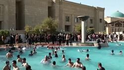 CLEAN : Iraq's Sadr supporters cool off in Baghdad government building pool News Clip