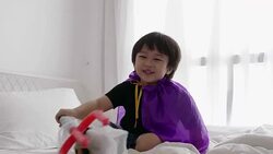 Thai boy with Halloween costume while acting and playing with Halloween skull and spear toy at home-Halloween concept Stock Footage