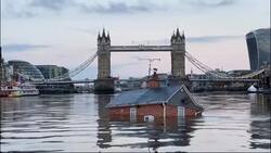 Extinction Rebellion floats British house mock-up "sinking" in Thames in climate protest News Clip