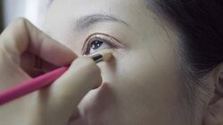 Professional make-up artist making up her model face Stock Footage