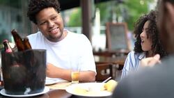 Friends talking and drinking beer in a bar Stock Footage