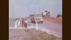 1970s: Crossing guard guides children across street Stock Footage