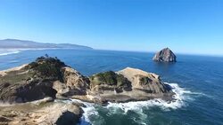 Pacific ocean coastal beach with Haystack Rock Stock Footage