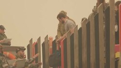 soldiers help load evacuees on to evacuation boat News Clip