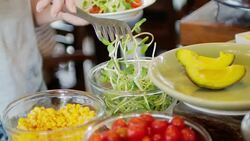 Woman hands selecting Vegetable from salad bar for Healthy food Stock Footage
