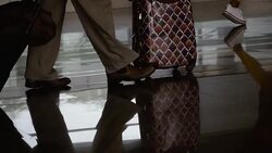 Airport . The feet of people pass with suitcases on wheels Stock Footage