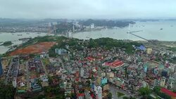 4k Aerial view over city and park with Bai Tho karst mountain Ha long bay. Halong City. Stock Footage