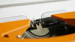 Side angle footage of a person writing ISLAMOPHOBIA on a typewriter Stock Footage