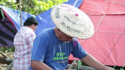 VOICED : In Borneo jungle natives stand up News Clip