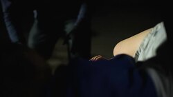 Male criminal opening car trunk and checking female victim pulse, kidnapping Stock Footage