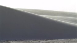 WIDE ANGLE OF WIND BLOWING OVER SAND DUNES. COULD BE WHITE SANDS NEW MEXICO. GYPSUM SAND. Stock Footage