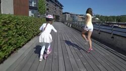 Two little girls Riding Kick Scooter Outdoors. Stock Footage