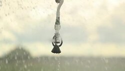 Pivot irrigation system. 120fps slow-motion close-up of pivot sprinkler system irrigating crops. Irrigation pivot system watering agriculture field Stock Footage