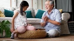 Senior man and little girl playing board game together at home. people with family, lifestyle, education concept. 4k resolution. Stock Footage