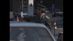Checkpoint Charlie and souvenier seller in Berlin News Clip