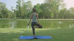 Young asian woman yoga outdoors keep calm and meditates while practicing yoga to explore the inner peace. Yoga and meditation have good benefits for health. Yoga Sport and Healthy lifestyle concept. Stock Footage