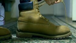 close up person ties warm winter classic shoelaces of boots Stock Footage