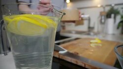 Young woman preparing lemonade Stock Footage
