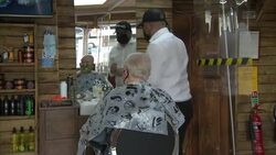 Men having haircuts in a barbers' after lockdown easing News Clip