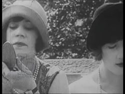 The 1920s flapper girl, various shots of women dancing, smoking, shopping, putting on make-up, in salon. F Scott Fitzgerald writing. Stock Footage