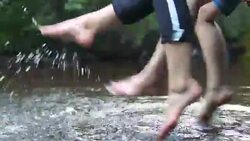 Teens relaxes by the river sitting on the edge of a wooden jetty. Stock Footage