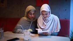 Lovely smiling Arabic women spending time together at a cafe Stock Footage