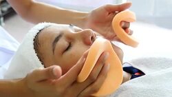 Young women laying for face cleansing before face mask. Face therapy an skin care. Stock Footage