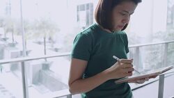 Designer drawing a sketch on tablet using stylus at city Stock Footage