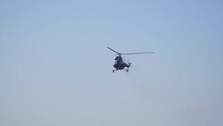 The helicopter flies in the clear sky Stock Footage